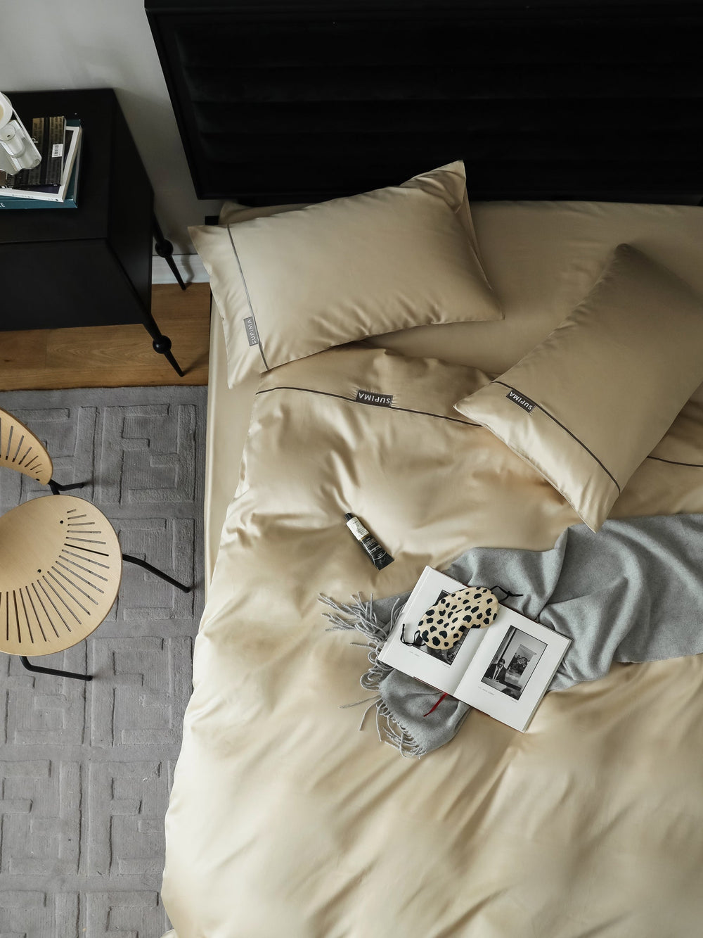 Warm ivory bedding with dark piping in a modern bedroom